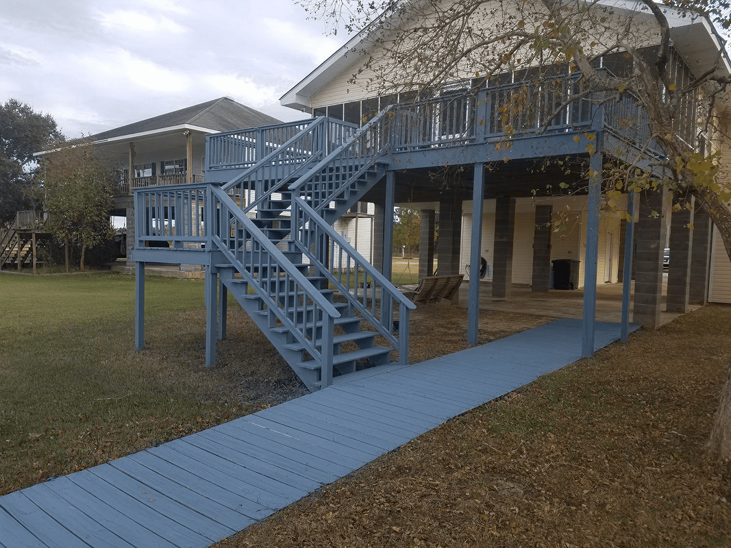 Elevated house with blue wooden stairs