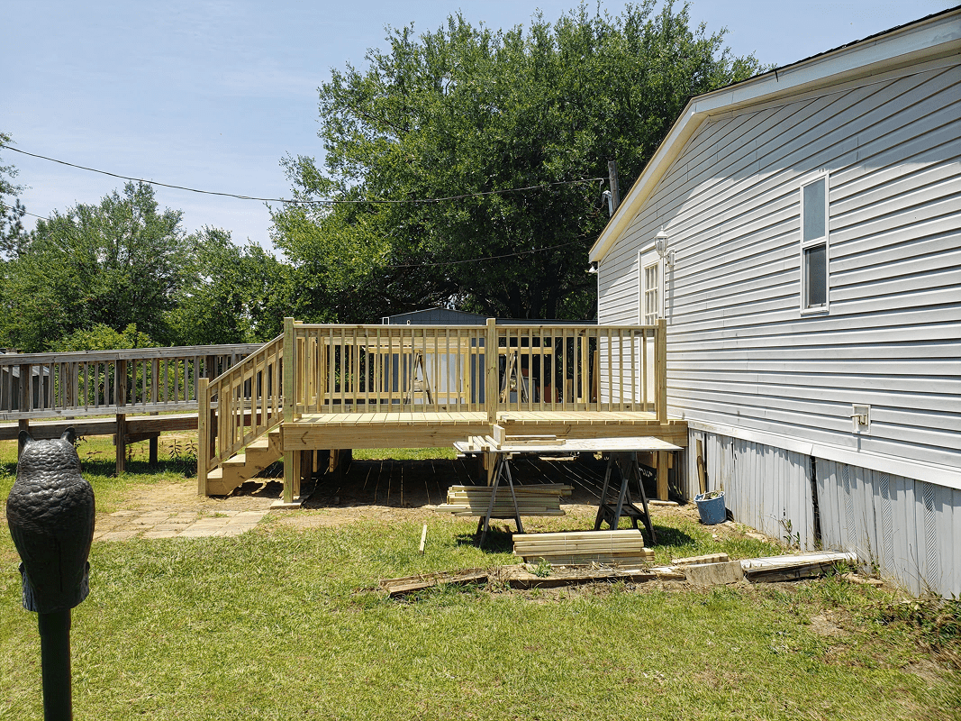 Mobile home with attached wooden deck