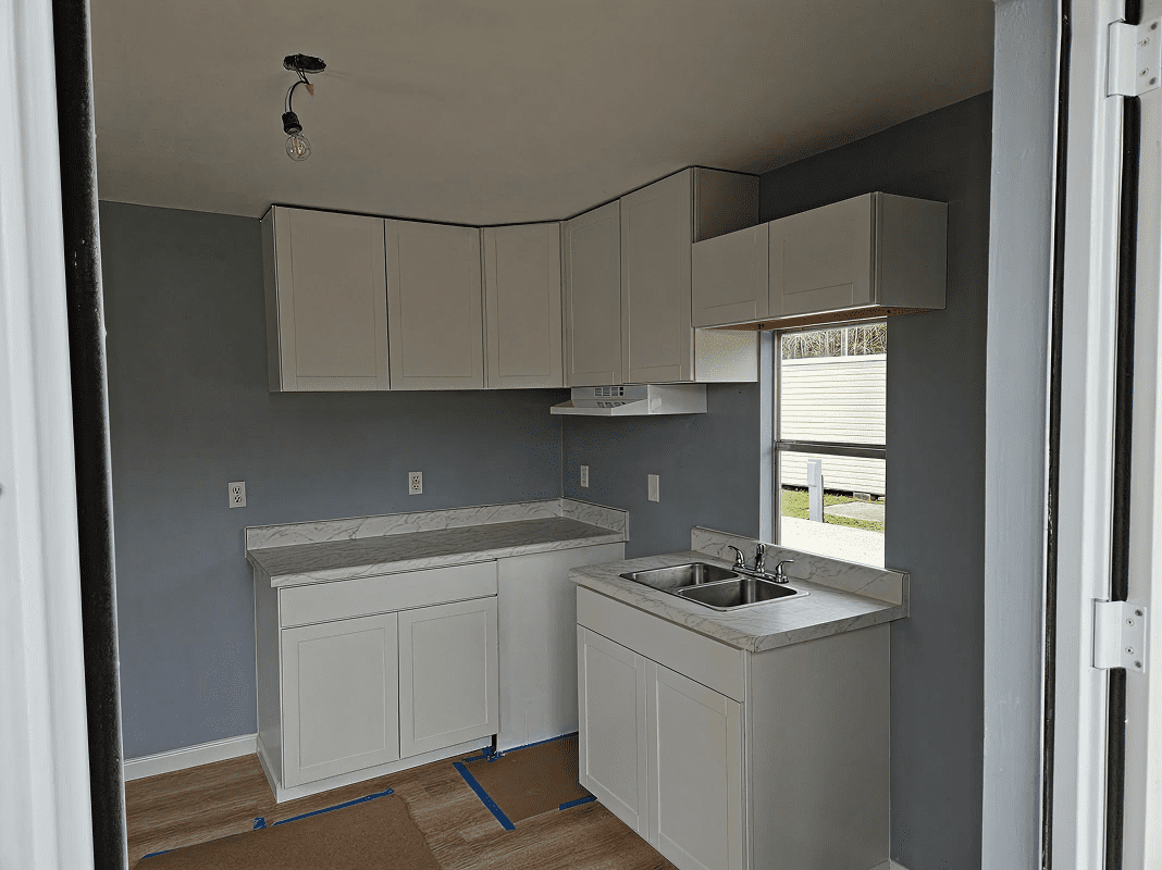 Small kitchen with white cabinets